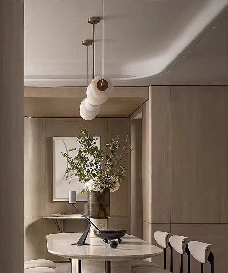 Modern dining room interior featuring an alabaster linear chandelier