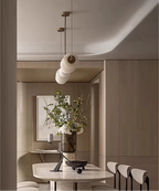 Modern dining room interior featuring an alabaster linear chandelier