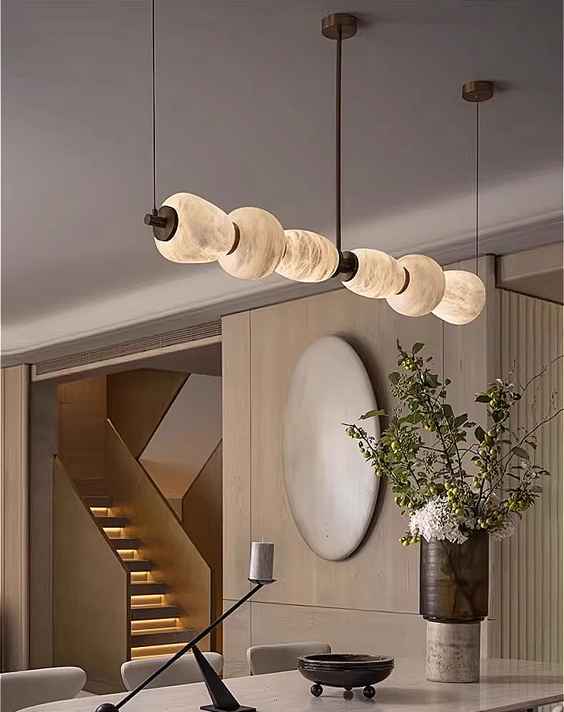 Alabaster linear chandelier in a quiet luxury dining room interior