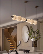 Alabaster linear chandelier in a quiet luxury dining room interior