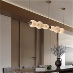 Alabaster linear chandelier in a modern luxury dining room interior