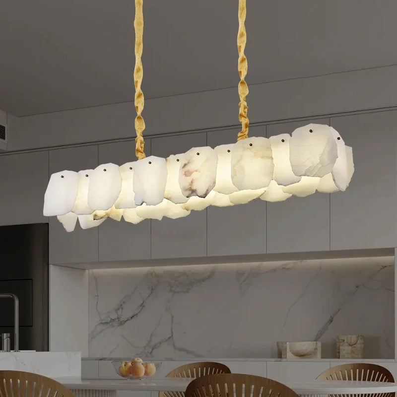 Alabaster linear pendant light over modern luxury kitchen island, gold stone chandelier in neutral contemporary kitchen