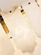 Drum-shaped alabaster chandelier illuminating a modern living room interior