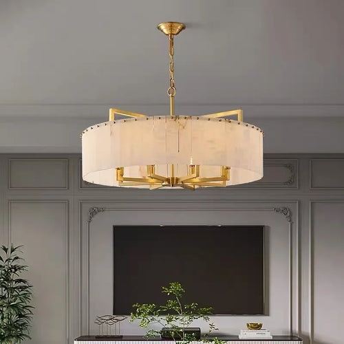 Gold alabaster drum chandelier in a modern luxury interior with elegant architectural details