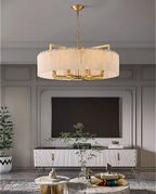Gold alabaster drum chandelier in a modern interior with refined architectural details