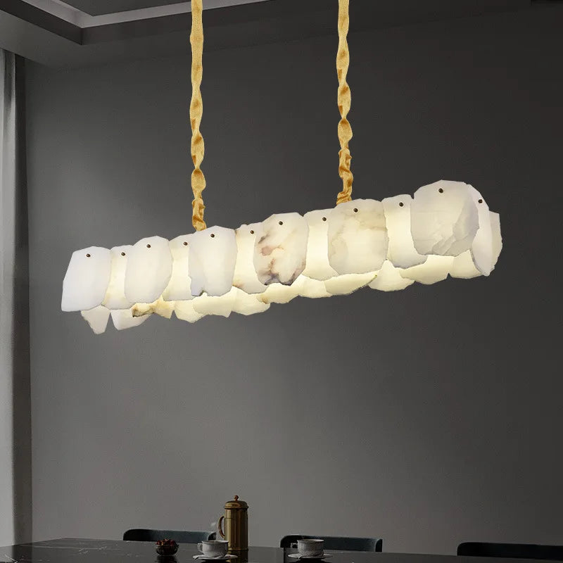 Sculptural alabaster chandelier in quiet luxury dining room, soft daylight linear pendant in calm modern interior