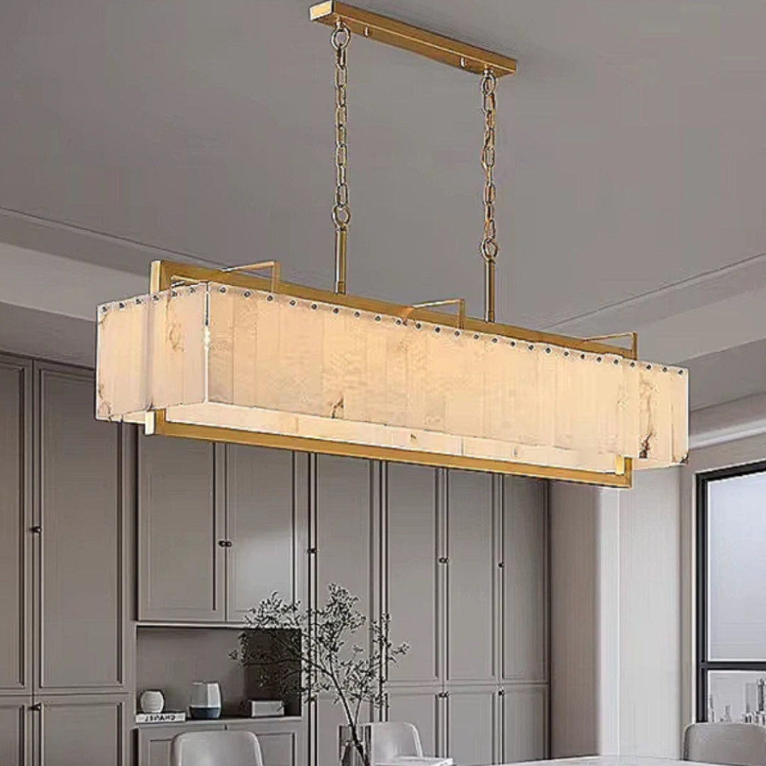 alabaster linear chandelier over luxury modern dining room with gold frame and neutral palette