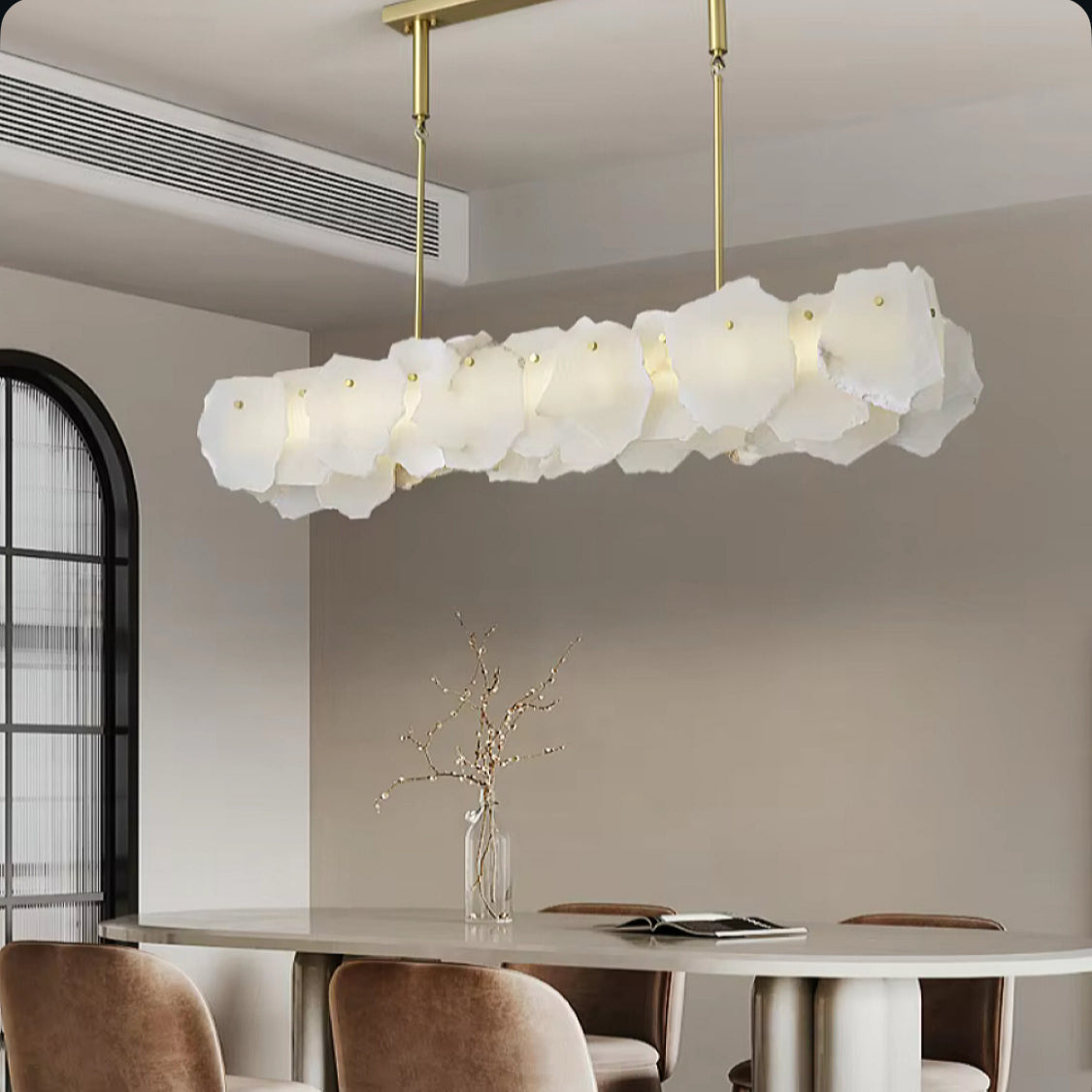 Alabaster linear chandelier in modern luxury neutral dining room, gold pendant light above dining table, minimalist interior design