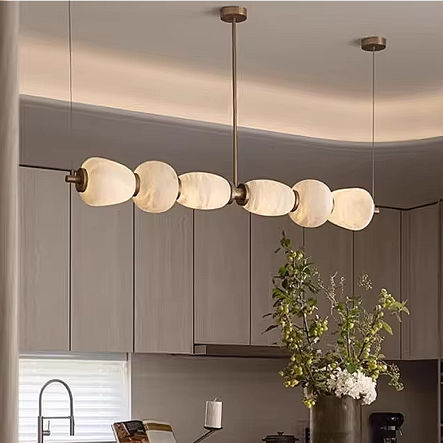 Alabaster linear chandelier in a modern neutral dining room interior