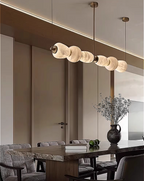 Alabaster linear chandelier in a quiet luxury dining room interior