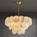 3-tier spanish alabaster chandelier illuminating a contemporary dining space in natural stone