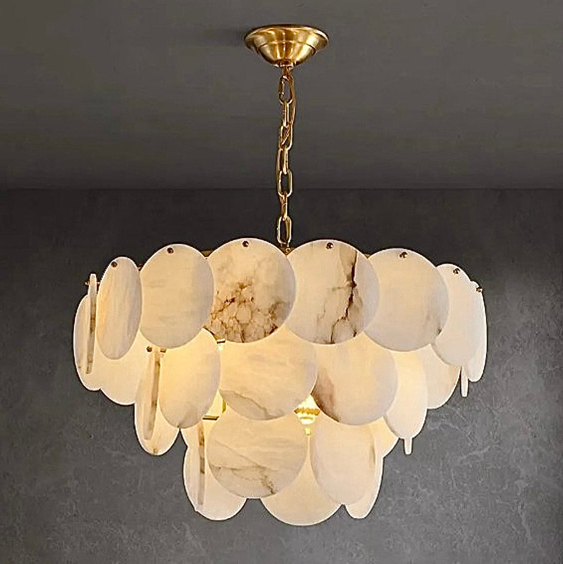 3-tier spanish alabaster chandelier illuminating a contemporary dining space in natural stone